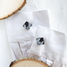 Load image into Gallery viewer, Cufflinks with a black pine tree pattern are styled on the cuffs of a white shirt, against a white background.