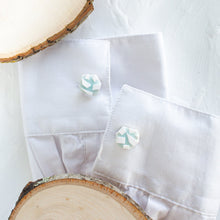 Load image into Gallery viewer, Cufflinks with a white and blue glacier pattern are styled on the cuffs of a white shirt, against a white background.