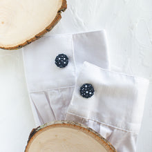 Load image into Gallery viewer, Cufflinks with a starry night sky pattern are styled on the cuffs of a white shirt, against a white background.