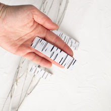 Load image into Gallery viewer, Hand holds a medium birch bark polymer clay barrette.