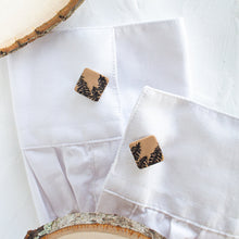 Load image into Gallery viewer, Cufflinks with a brown pine tree pattern are styled on the cuffs of a white shirt, against a white background.
