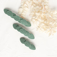 Load image into Gallery viewer, Group of olive green leaf textured polymer clay hair barrettes.

